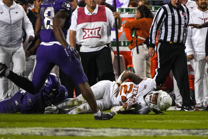 Texas Longhorns running back Jonathon Brooks (24) is brought down by TCU cornerback Josh Newton (3) during the game at Amon G. Carter Stadium on Saturday, Nov. 11, 2023 in Fort Worth, Texas